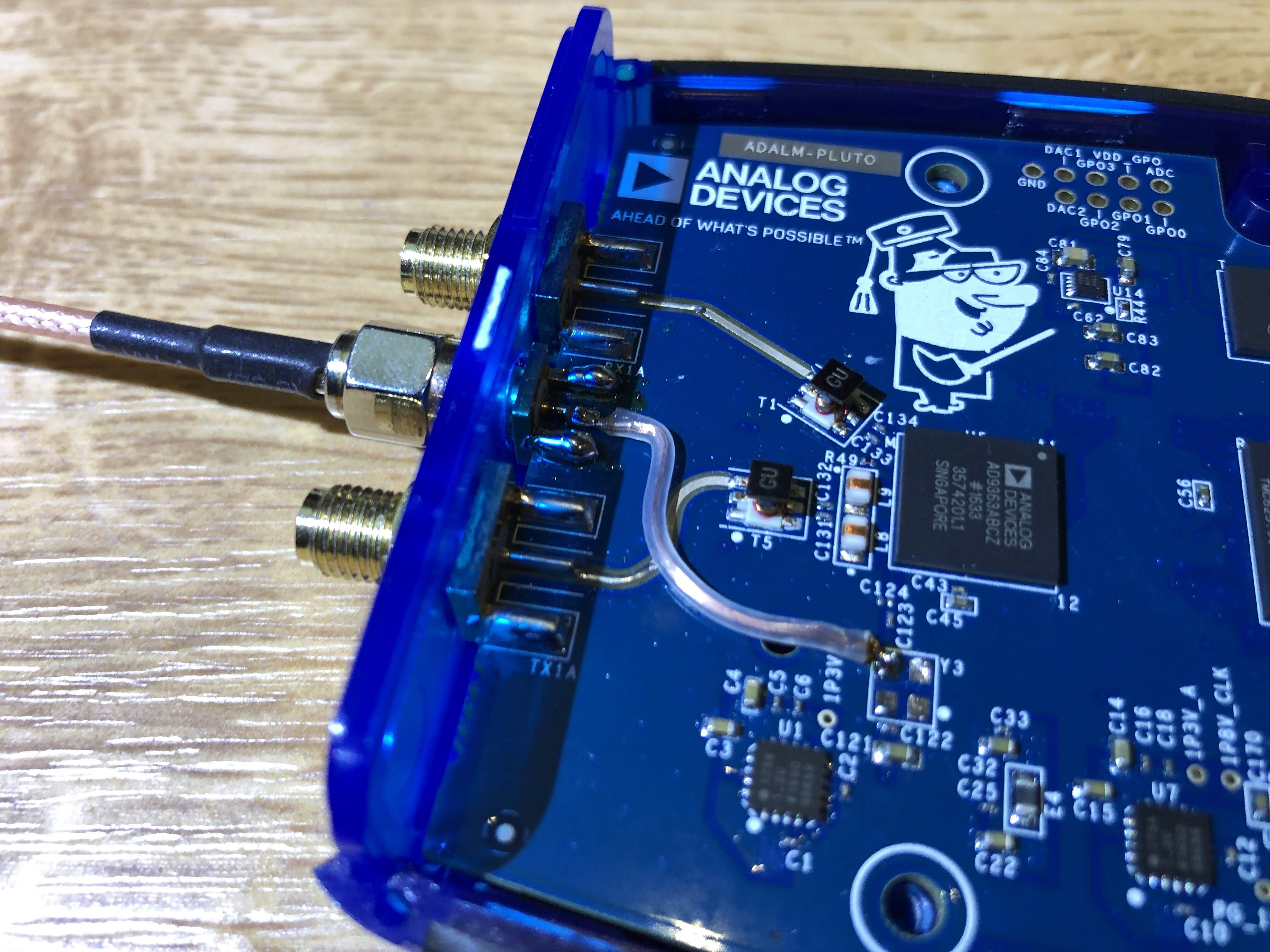 PlutoSDR PCB with wire from 3rd/middle SMA jack to upper-left pin of the Y3 footprint