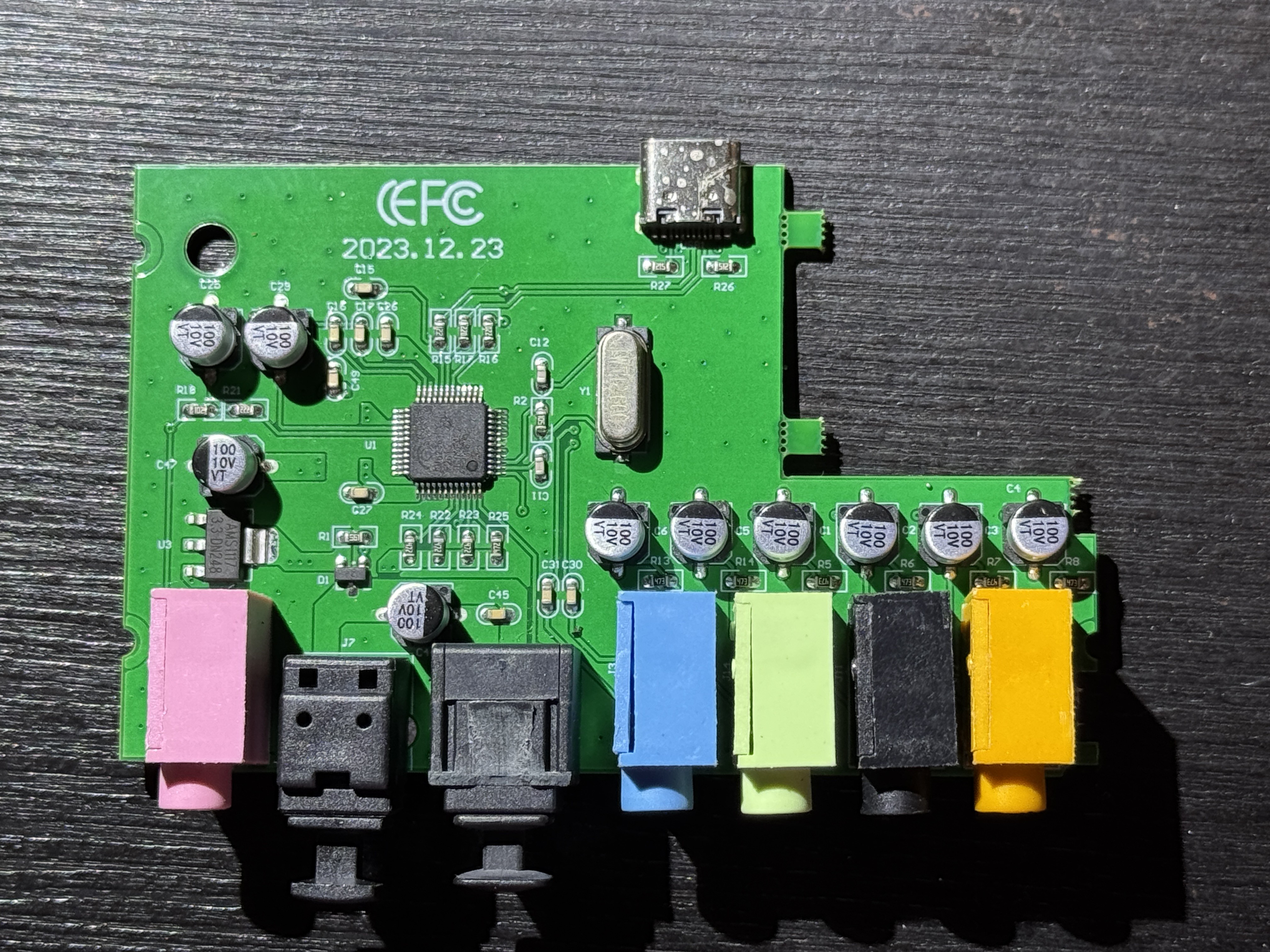 PCB of that sound card, only a single QFP CM6206 chip, 12 MHz crystal oscillator and a 3.3V regulator